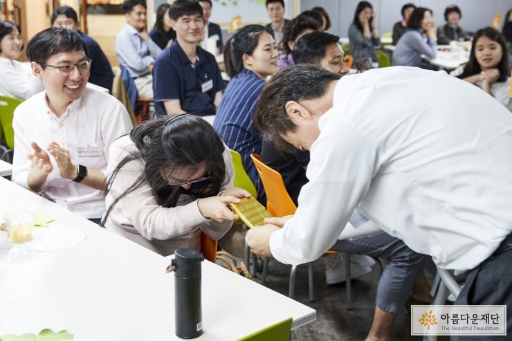 권찬 사무총장이 이벤트에 참여해 준 기부자에게 선물을 전달하고 있다