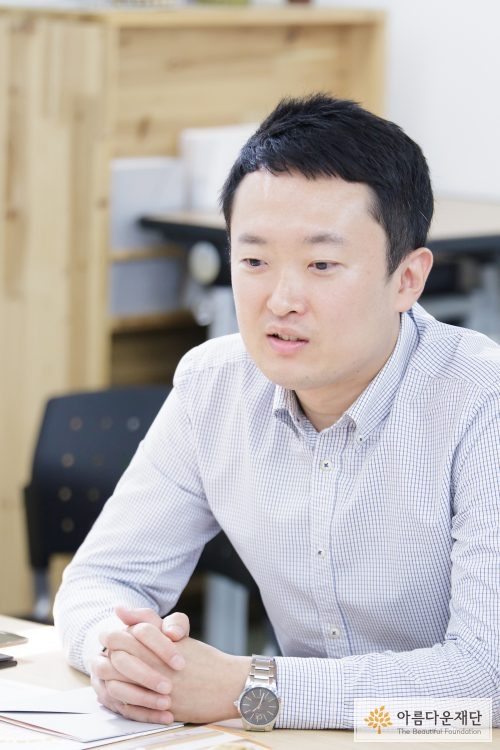 체크셔츠를 입고 앉아있는 남자